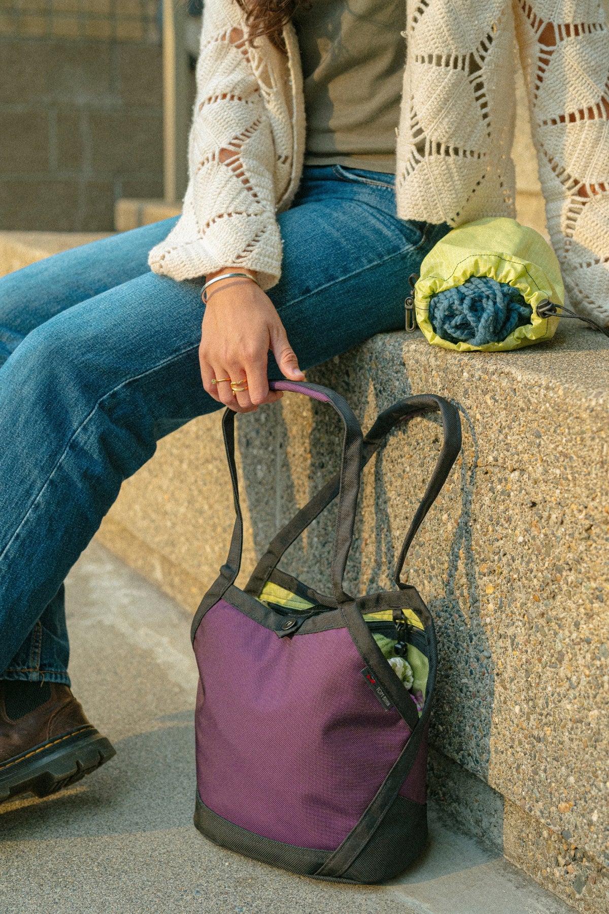 lifestyle visible^^A person sitting beside a Little Swift on a doorstep.