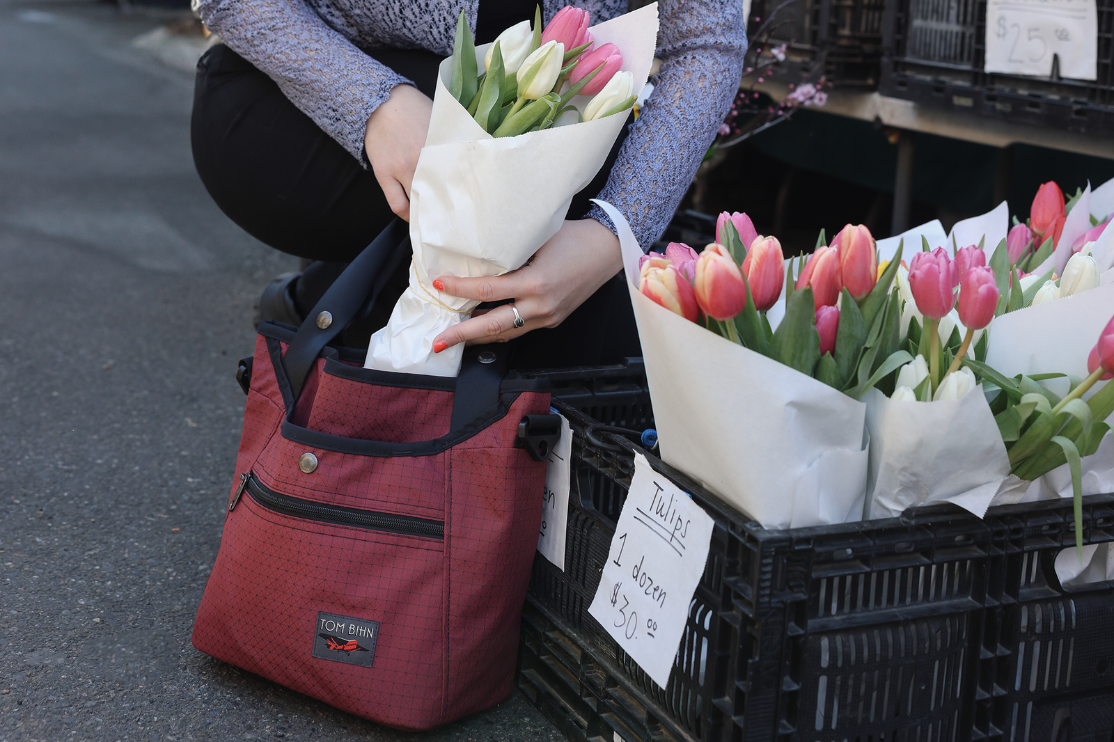 visible lifestyle^^A person placing a boquet of tulips in a Forager