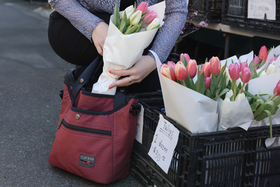 visible lifestyle^^A person placing a boquet of tulips in a Forager