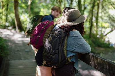 lifestyle visible^^a group hiking carrying Guide's Edition Synik 26 in Ursa Brown, Raspberry pink, and a Saguaro green