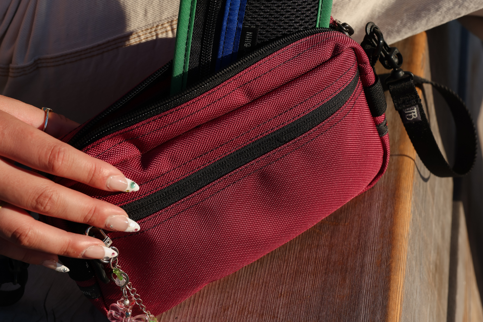 lifestyle visible^^ Person pulling a Mystery Organizer Pouch out of Side Effect