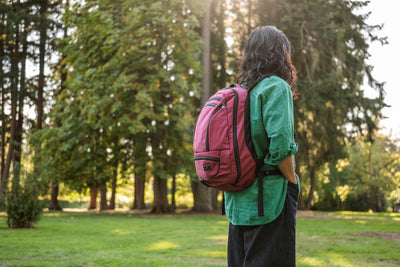 visible lifestyle^^A person wearing a Synik 26 in a wooded area