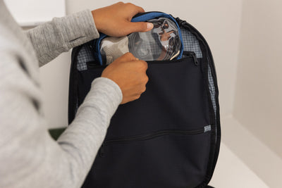 visible lifestyle^^A person removing a 3D Organizer Cube from a sewn-in organizer pocket in the main compartment.