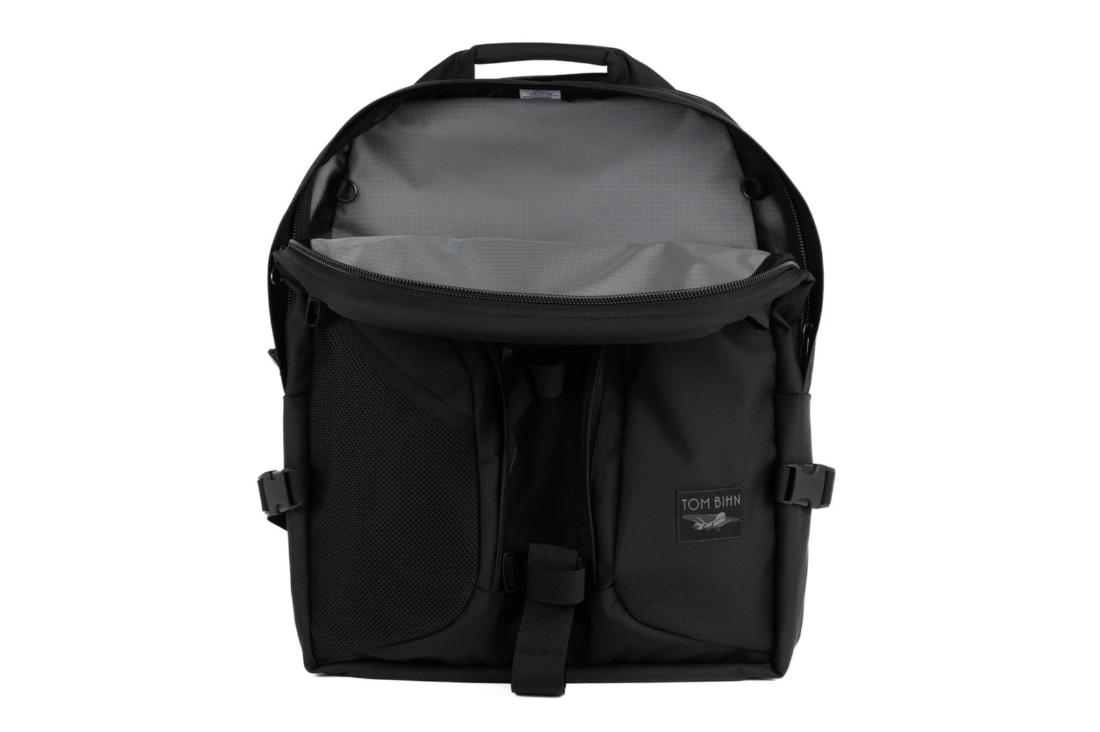 visible variant TB0114-BKGL^^The Brain Bag in Nebulous Grey (dark grey) Ballistic with the front main compartment zipper opened to reveal its Mountain Grey (grey with light grey grid) 210 Cerylon interior.