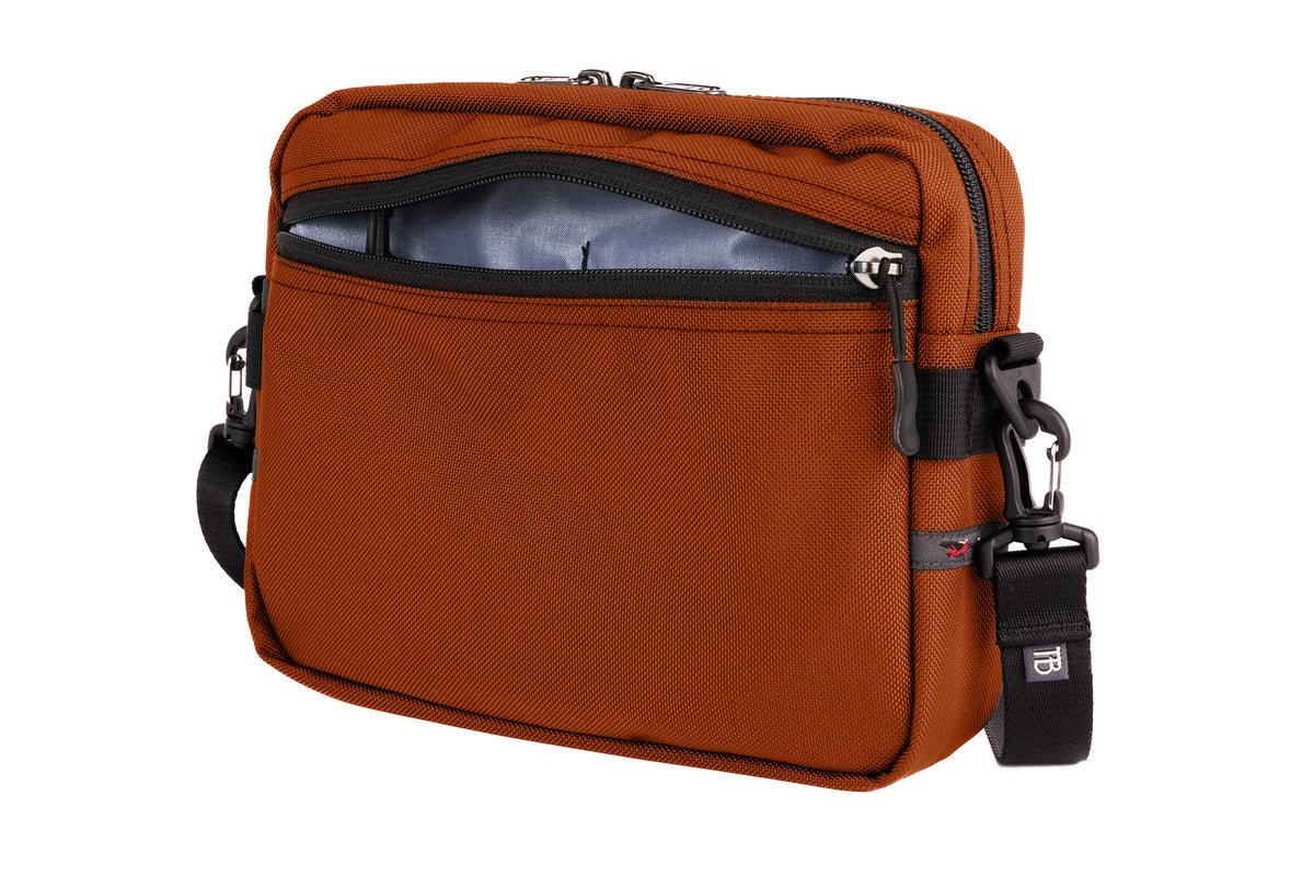 visible variant TB0414-TKDL^^The Side Kick in Burnt Orange Ballistic with an Dusk (bluish-purple with dark bluish-purple grid) 200 Halcyon interior.