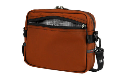 visible variant TB0414-TKND^^The Side Kick in Burnt Orange Ballistic with an Northwest Sky (light grey with white grid) 200 Halcyon interior.