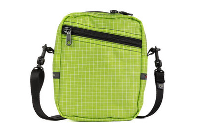 visible variant TB0416-1DGE^^Front photo of an Everyday Cubelet in Kiwi Halcyon (bright green with a white grid) with a front zipper.