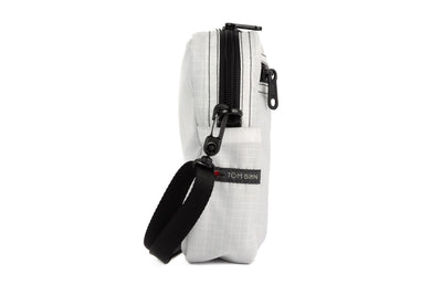 visible variant TB0416-TDGE^^A profile shot of an Everyday Cubelet in Tahoma Halcyon (white with a white grid) with a front zipper.