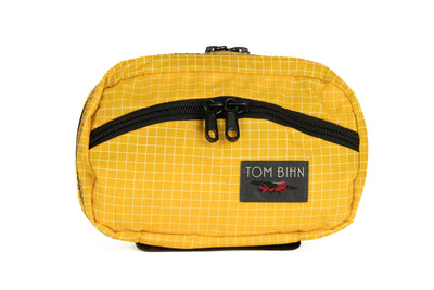 visible variant TB0418-OD^^The front of a Handy Little Thing #1 in Solaris (yellow with white grid) 200 Halcyon showing the front zipper with two slider and logo at the bottom-right corner.