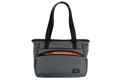 visible variant TB0715-GKZD^^Photo of the Nomad Tote in Nebulous Grey Ballistic with Zest (orange with white grid) 200 Halcyon interior.