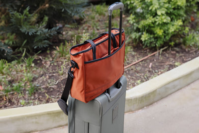 visible detail^^The Nomad 16 on roll-aboard bag using its handle passthrough.