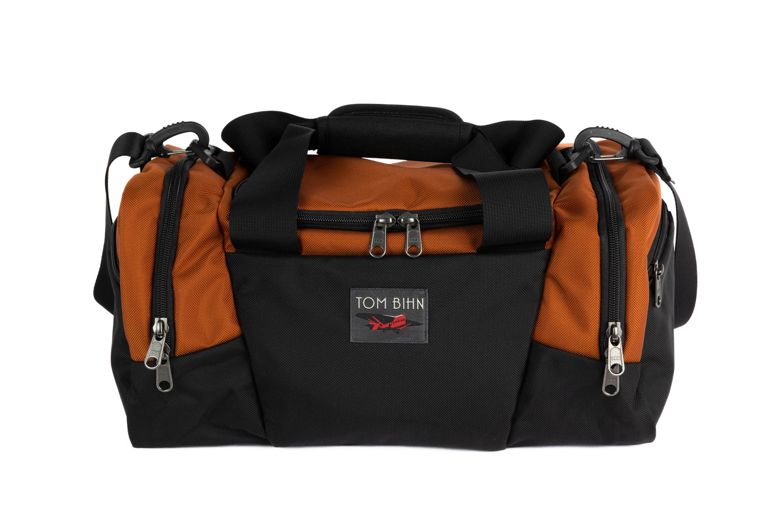 visible variant TB0904-TKGL^^The Night Flight Travel Duffel in Burnt Orange Ballistic.