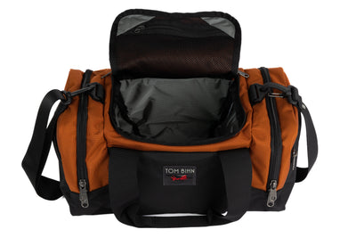 visible variant TB0904-TKGL^^The Night Flight Travel Duffel in Burnt Orange Ballistic with a Mountain Grey 210 Cerylon interior.