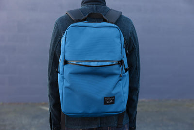 Person wearing the Paragon 2.0 on their back with the front pocket open.