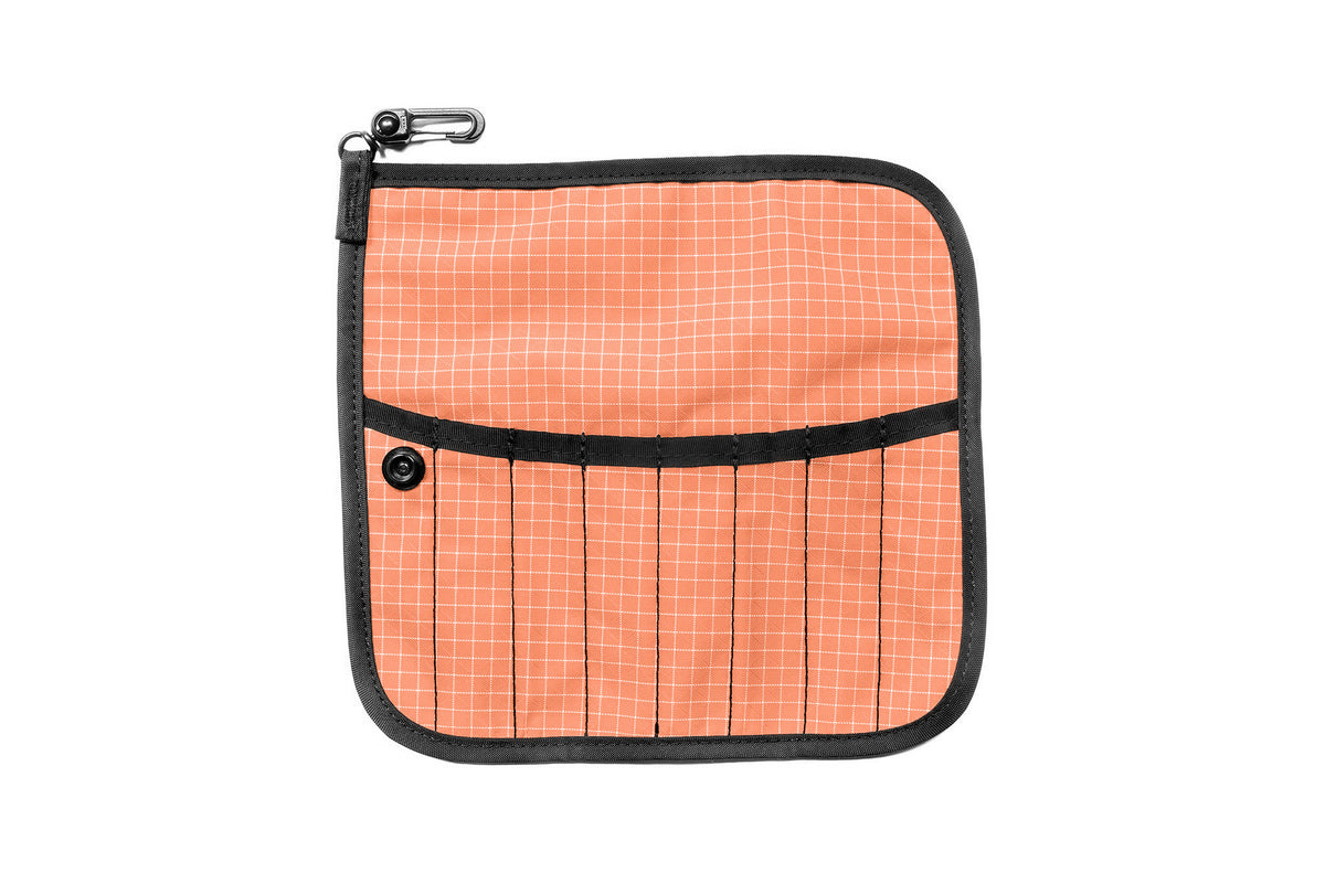 visible variant TB1235-3D^^The front of a Tool Pen Wrap in Cantaloupe (pale orange with white grid) 200 Halcyon.