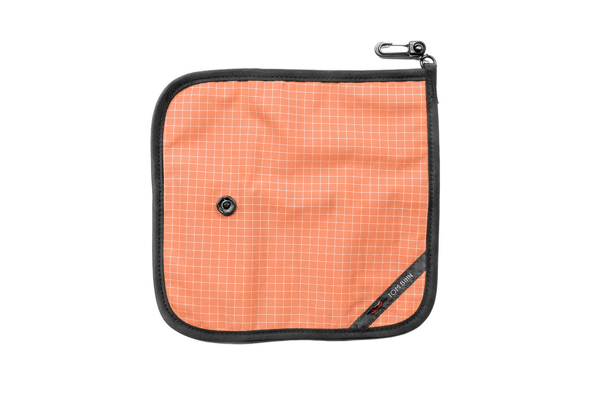 visible variant TB1235-3D^^The front of a Tool Pen Wrap in Cantaloupe (pale orange with white grid) 200 Halcyon.