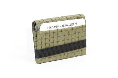 visible variant TB1275-VH^^The Size 5 Nik's Minimalist Wallet in Taiga (olive green with grey grid) 400 Halcyon closed with the attached elastic band.