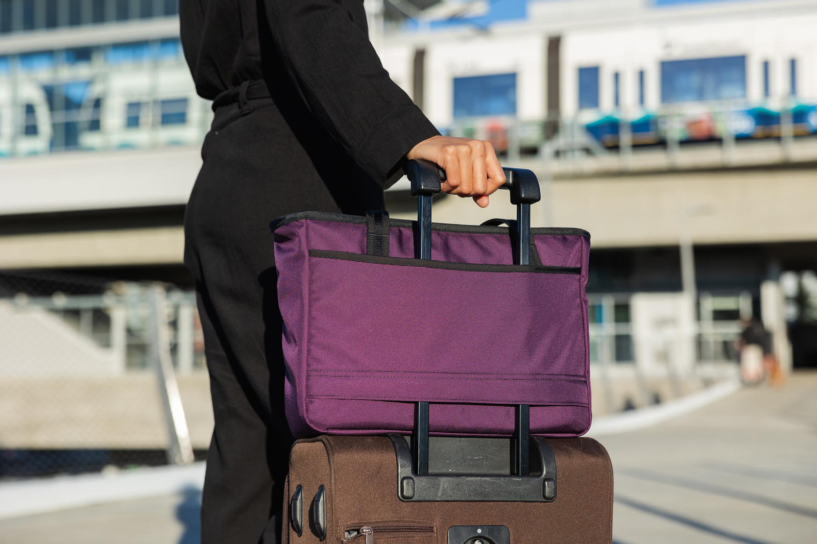 visible detail^^A Nomad attached to rolling luggage using the handle pass-through.