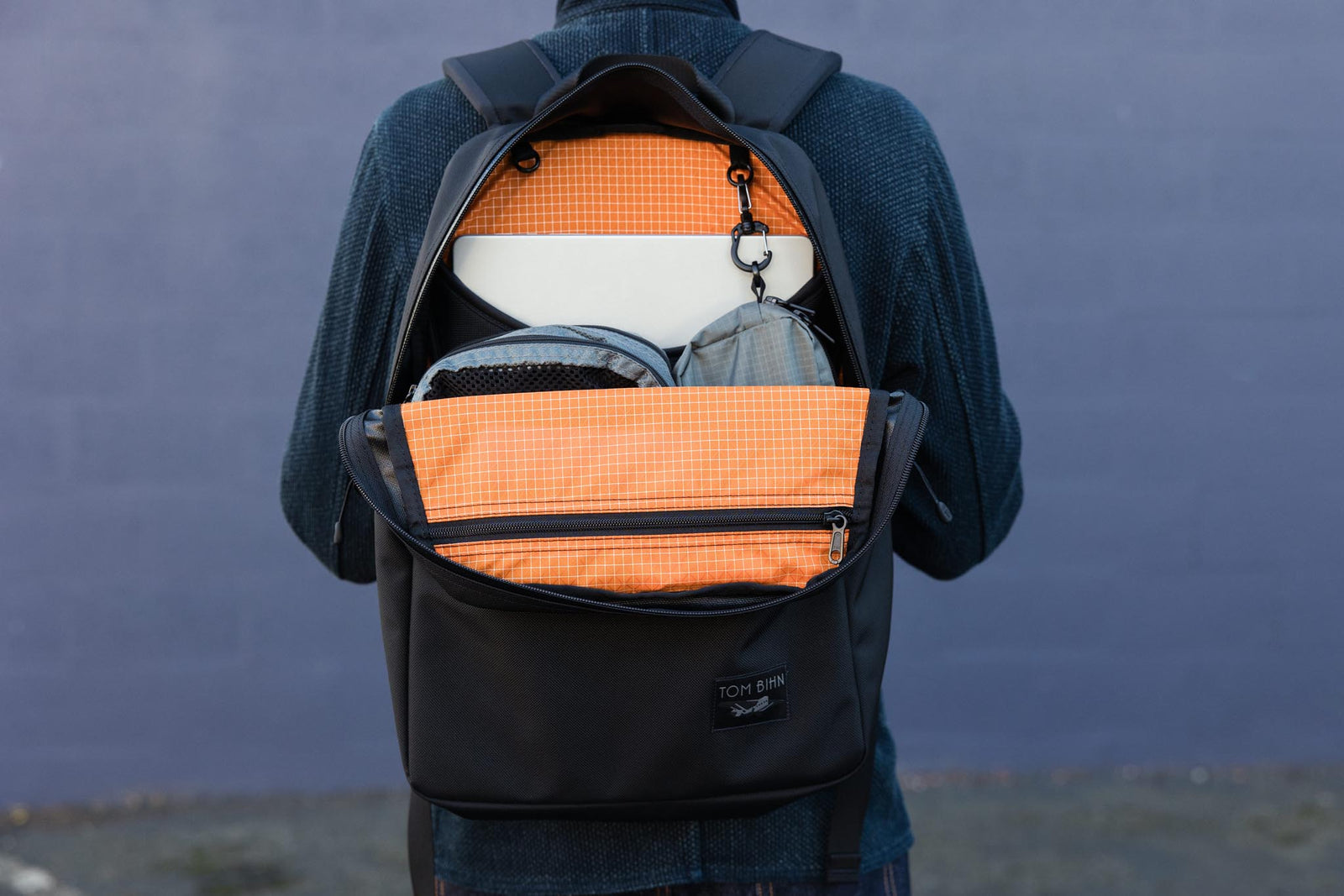 visible detail^^An open backpack with bright orange interior