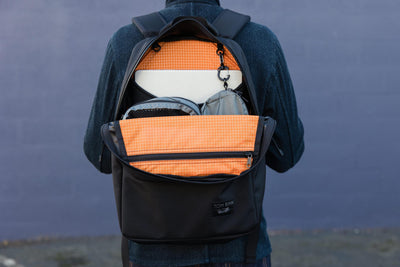 visible detail^^An open backpack with bright orange interior