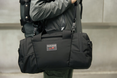 visible lifestyle^^A person shoulder carrying the Night Flight Travel Duffel.