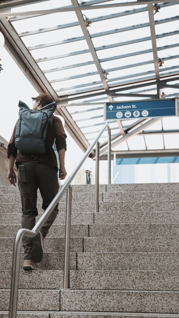 Person wearing Adept Roll-Top Backpack in Nebulous Gray Ballistic
