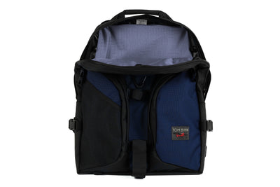 visible variant TB0114-DKDL^^The Brain Bag in Deep Blue (dark blue) 630 Ballistic with the front main compartment zipper opened to reveal its Moss (green with light green grid) 210 Cerylon interior.