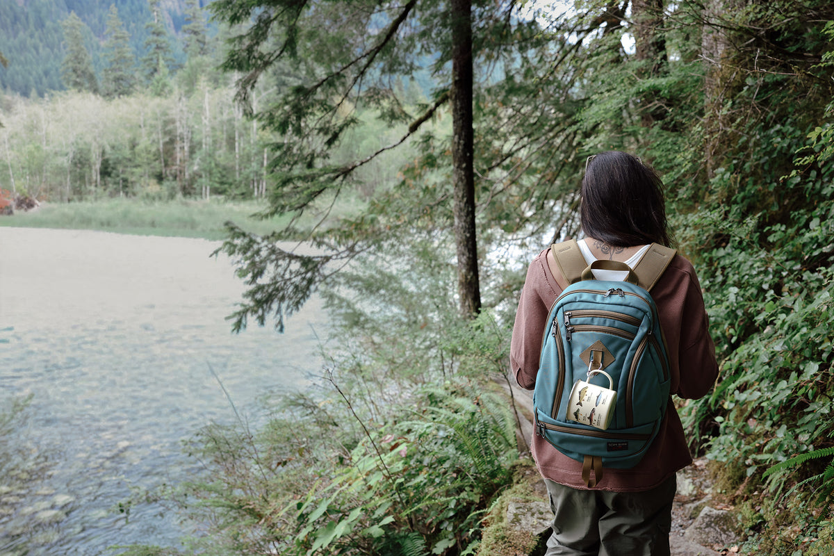 visible lifestyle^^A person carrying a GE Synapse 19 on a riverside trail.