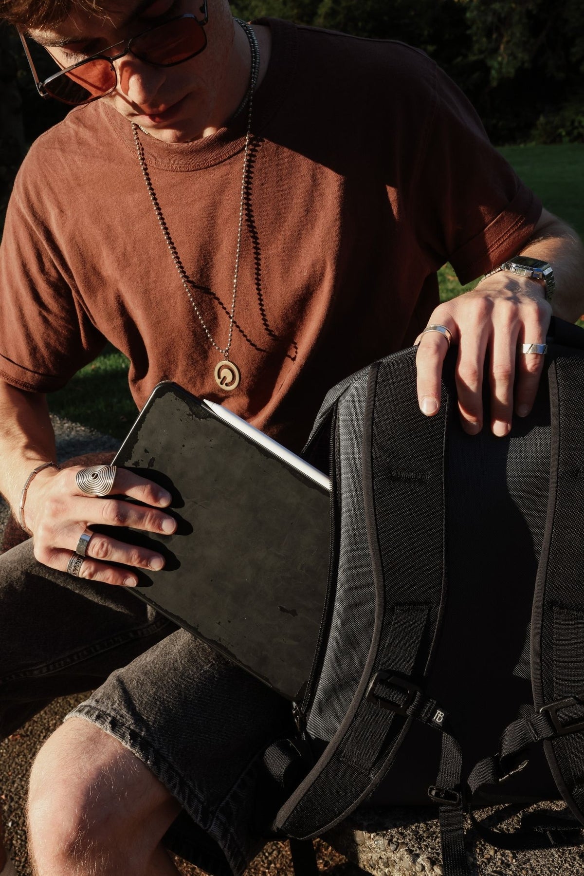 visible lifestyle^^ Person putting tablet into back pocket of Luminary. 