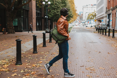 visible lifestyle^^A person crossing a street wearing a Marathon Messenger