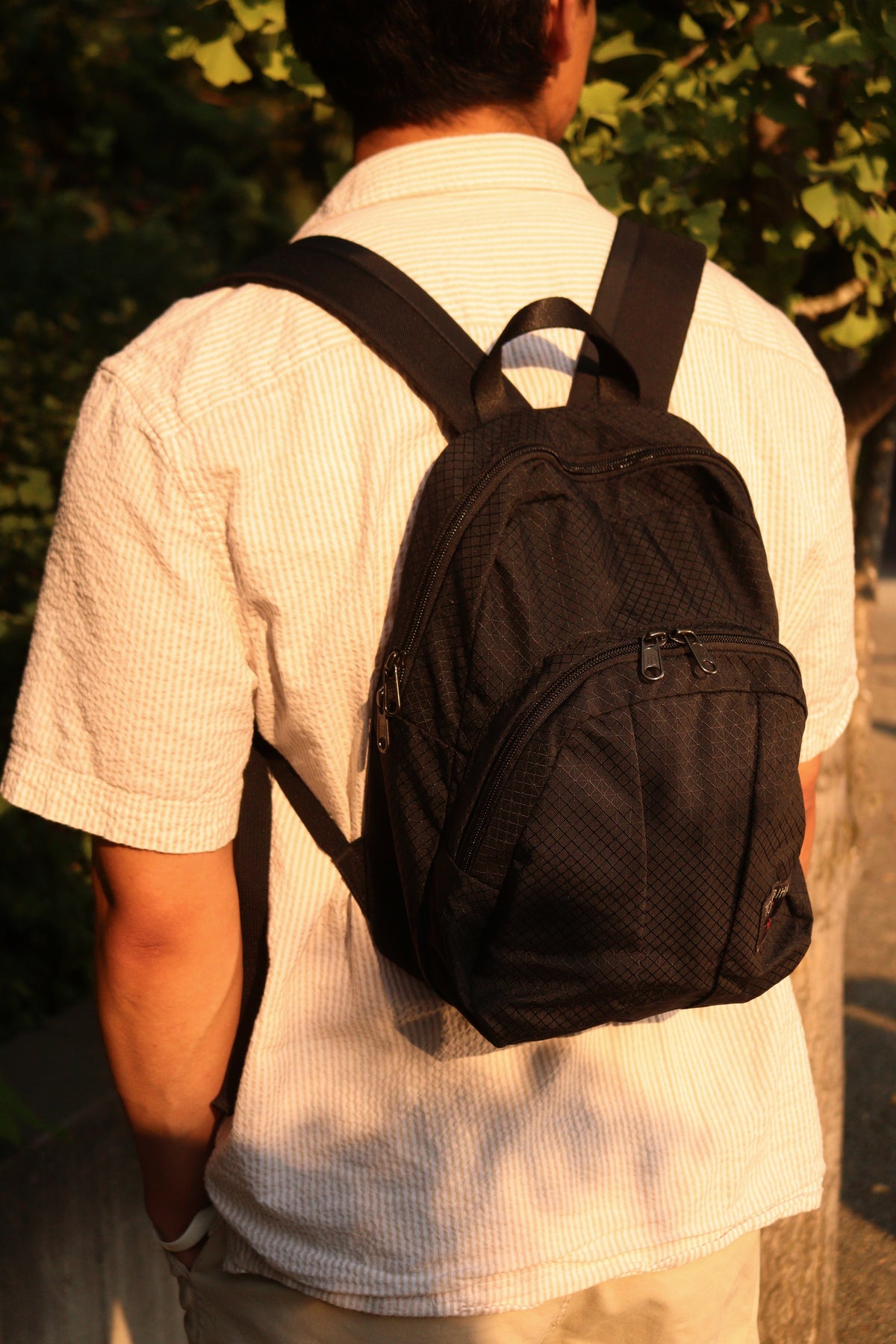 visible lifestyle^^ Paradigm in Black Spectron worn on man's back.