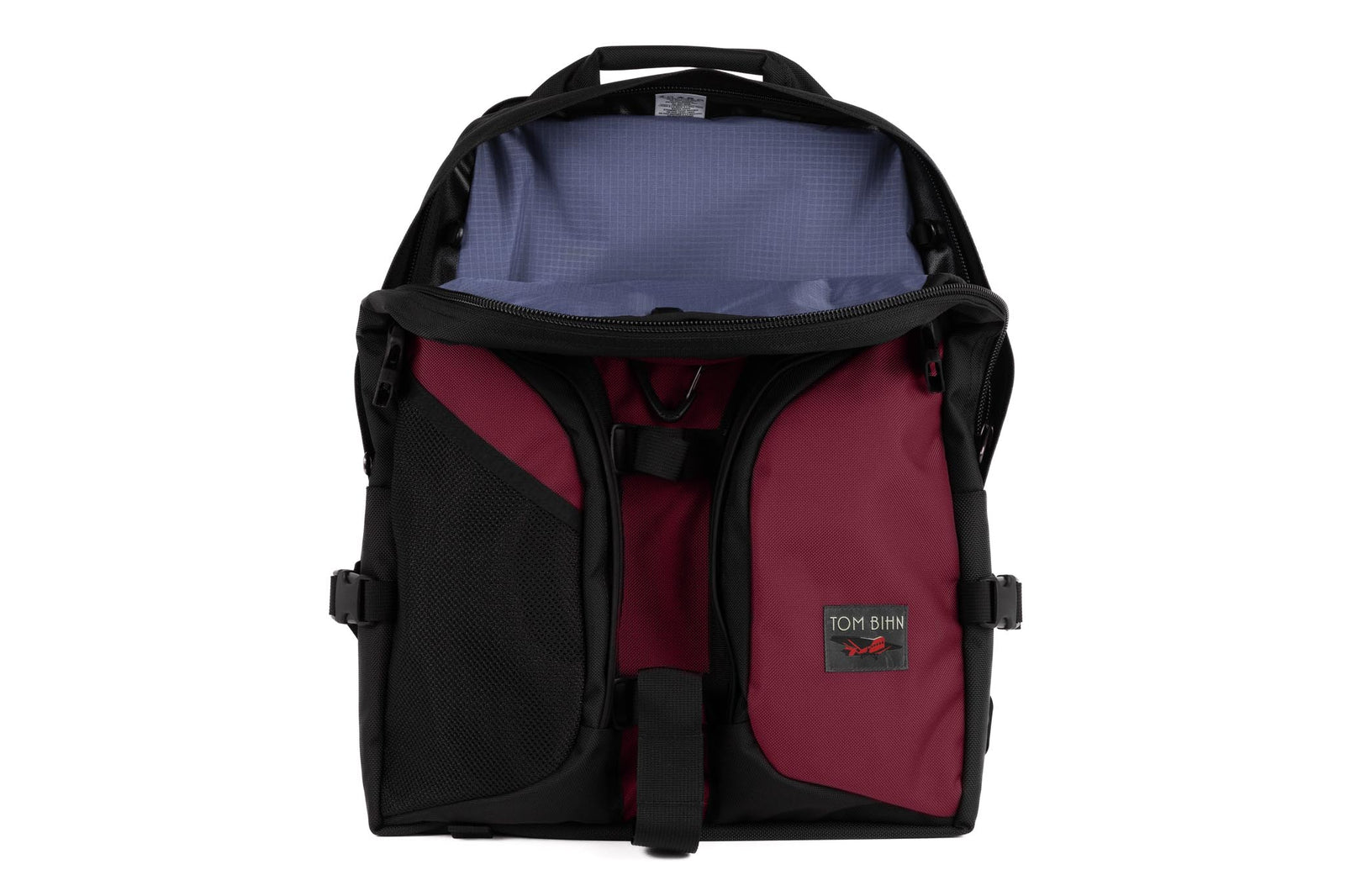visible variant TB0114-PKDL^^The Brain Bag in Raspberry Ballistic with the front main compartment zipper opened to reveal its Dusk (purplish-blue with light blue grid) 210 Cerylon interior.