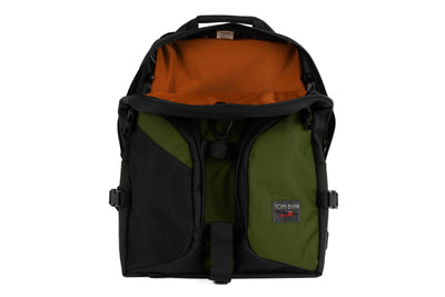 visible variant TB0114-VKPL^^The Brain Bag in Saguaro (olive green) Ballistic with the front main compartment zipper opened to reveal its Persimmon (dark orange with light orange grid) 210 Cerylon interior.