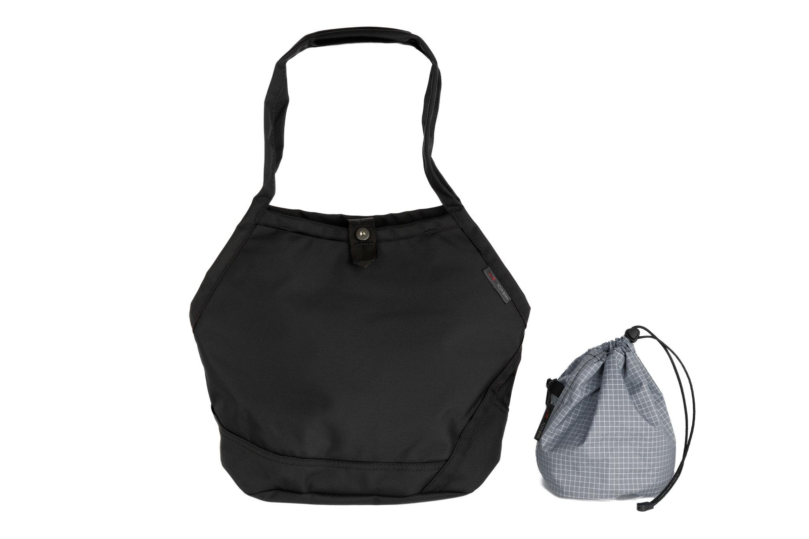 visible variant TB0660-BKND^^A Swift in Black Ballistic with Northwest Sky (light grey with white grid) 200 Halcyon interior and Yarn Stuff Sack.