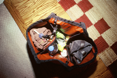 visible lifestyle^^An overhead shot of a Truck filled with a sweater, keys, snacks, and another bag.