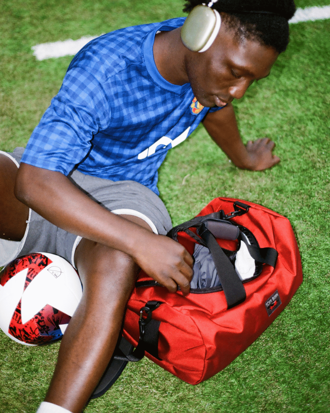 lifestyle visible^^A person sitting by a packed Small Yeoman Duffel.