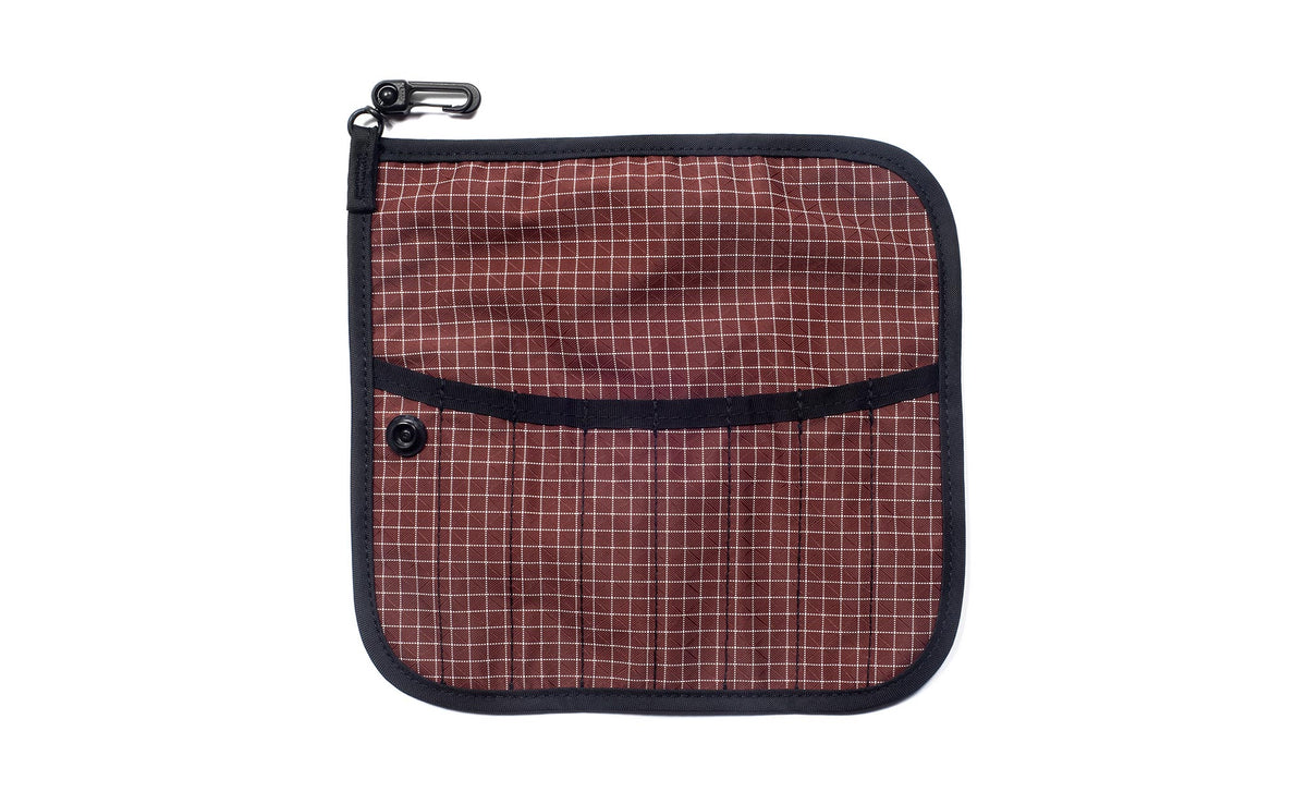 visible variant TB1235-6D^^The front of a Tool Pen Wrap in Moab (brick red with white grid) 200 Halcyon.