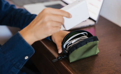 visible lifestyle^^A mini Q-Kit with a Lightning cable coiled inside it.