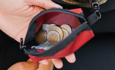 visible lifestyle^^A mini Q-Kit with pesos (coins and bills) in it.