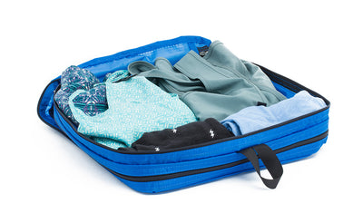 visible variant TB90505-LE^^An open Island (blue) Aether Large Laundry Aeronaut 30 Packing Cube holding a change of clothes.