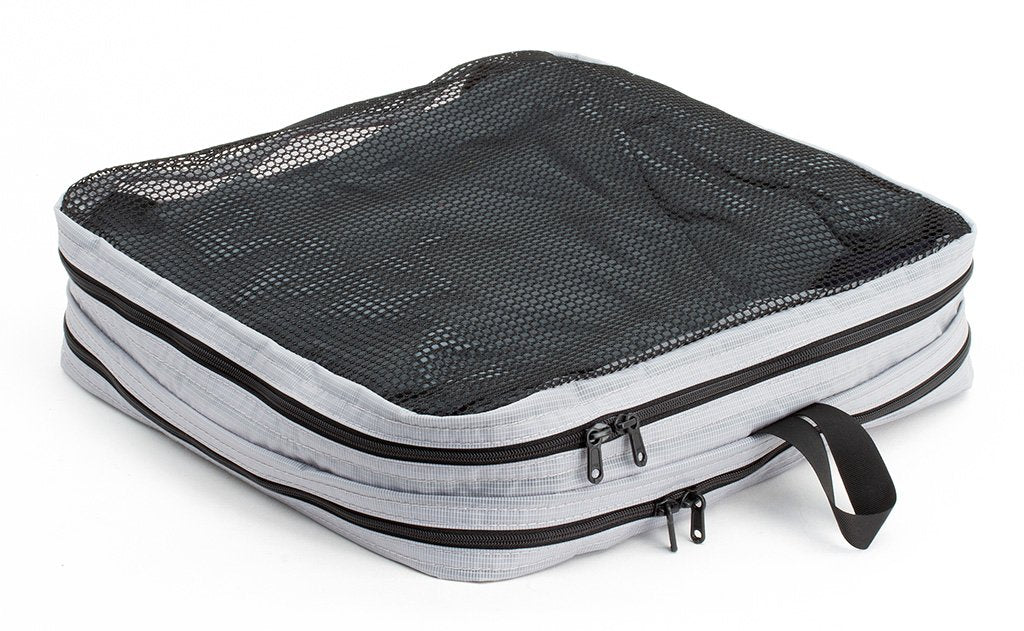 visible variant TB90505-NE^^A filled and zipped closed Northwest Sky (light grey) Aether Large Laundry Aeronaut 30 Packing Cube mesh side up.