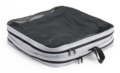 visible variant TB90505-NE^^A filled and zipped closed Northwest Sky (light grey) Aether Large Laundry Aeronaut 30 Packing Cube mesh side up.