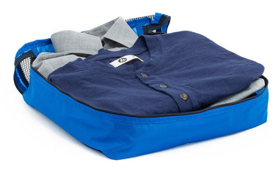 visible variant TB90604-LE^^A few button-down shirts folded in an open Island (blue) Large Aether Aeronaut 45 Packing Cube.