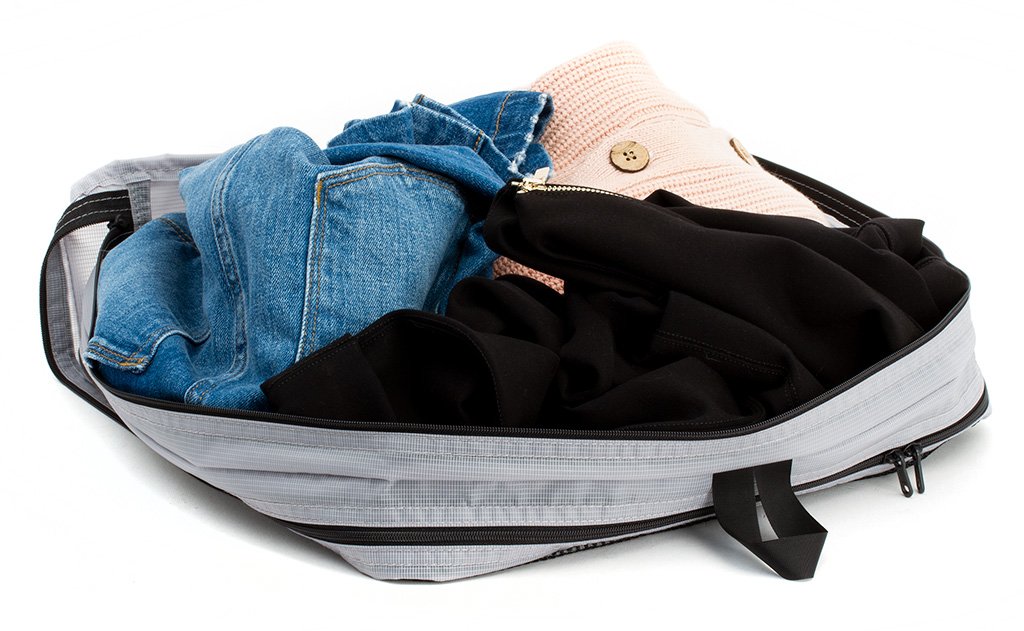visible variant TB90605-NE^^A change of clothes in an open Northwest Sky (light grey) Aether Large Aeronaut 45 Packing Cube all-fabric side up.