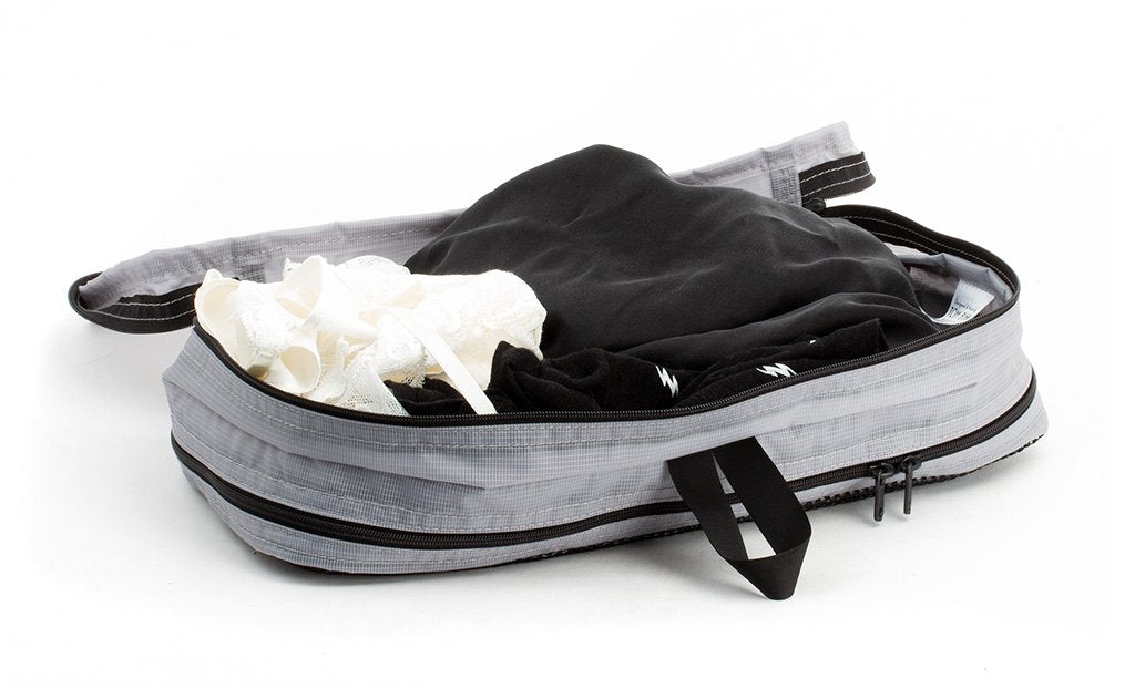 visible variant TB90601-NE^^A few pairs of undergarments in an open Northwest Sky (light grey) Aether Small Aeronaut 45 Packing Cube all-fabric side up.