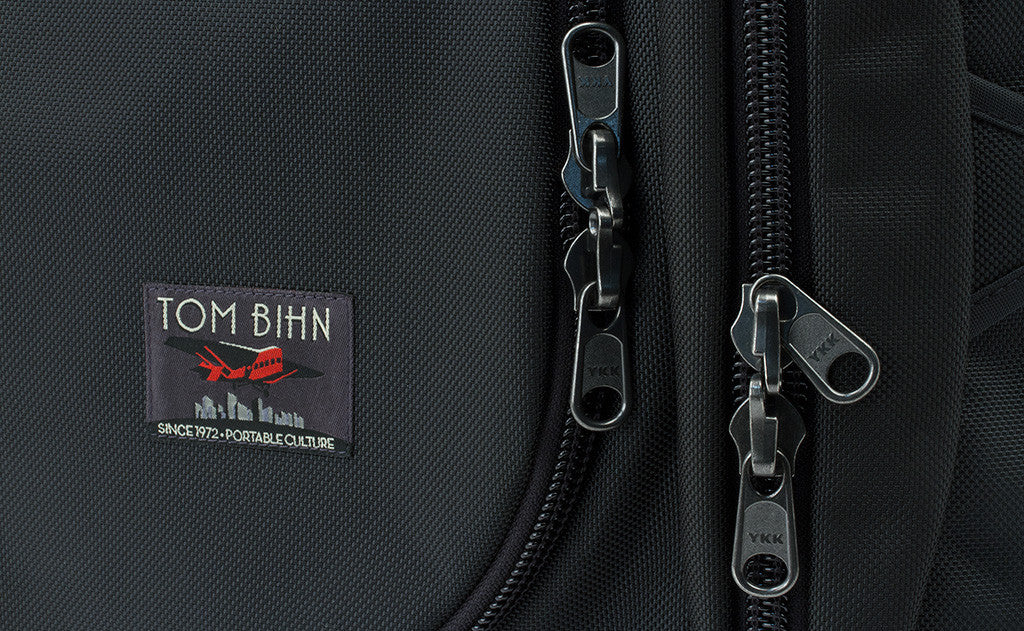 detail visible^^The main compartment and side pockets have locking zippers.