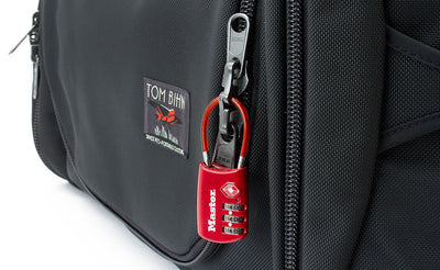 detail visible^^A standard TSA-compliant lock fits through the rings in the locking zipper.