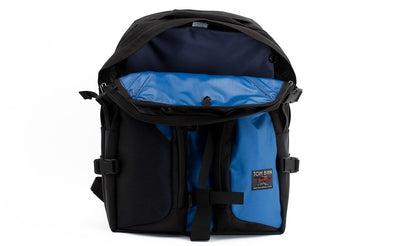 visible variant TB0114-NKLJ^^The Brain Bag in Constellation (light blue) 525 Ballistic with the front main compartment zipper opened to reveal its Cloud (light grey) 210 Ballistic interior.