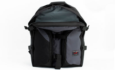 visible variant TB0104-GKLJ TB0114-GKLJ^^The Brain Bag in Nebulous Grey (dark grey) 525 Ballistic with the front main compartment zipper opened to reveal its Cloud (light grey) 210 Ballistic interior.