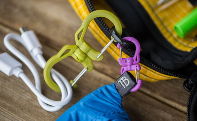detail visible^^a small Double Carabiner connecting a pocket travel pillow and a Medium Double Carabiner connecting a bit of cable to the same o-ring of a Handy Little Thing.